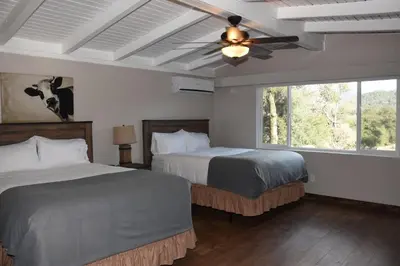 a bedroom with two beds and a ceiling fan at Apple Tree Inn in Julian