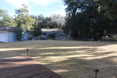 a yard with a house and a tree at Apple Tree Inn in Julian
