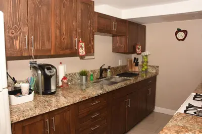 a kitchen with wooden cabinets and a sink at Apple Tree Inn in Julian