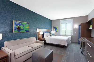 a hotel room with a bed and a couch at Home2 Suites By Hilton Temecula in Temecula