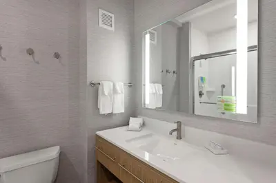 a white bathroom with a sink and a mirror at Home2 Suites By Hilton Temecula in Temecula