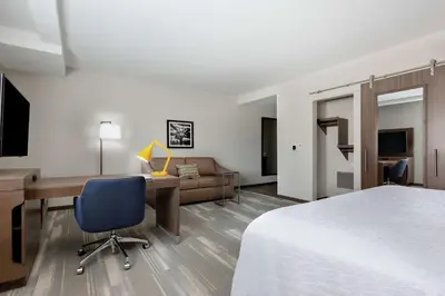 a hotel room with a bed and a desk and a chair at Hampton Inn & Suites San Diego Airport Liberty Station in San Diego