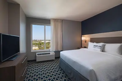 a hotel room with a bed and a large window at TownePlace Suites by Marriott San Diego Airport/Liberty Station in San Diego