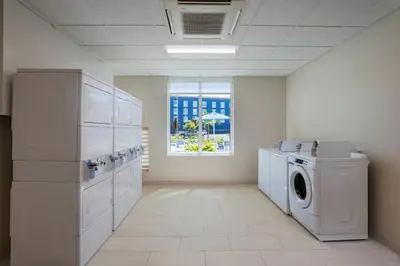 a laundry room with a washer and a window at TownePlace Suites by Marriott San Diego Airport/Liberty Station in San Diego