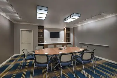 a meeting room with a wooden table and chairs at TownePlace Suites by Marriott San Diego Airport/Liberty Station in San Diego