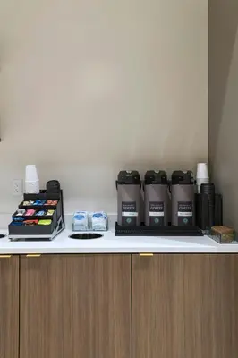 a counter with three coffee bottles on top of it at TownePlace Suites by Marriott San Diego Airport/Liberty Station in San Diego