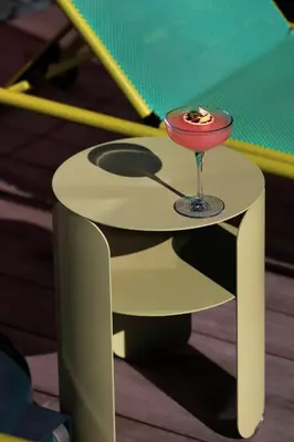 a yellow table with a martini glass on it at Alma San Diego Downtown, a Tribute Portfolio Hotel in San Diego