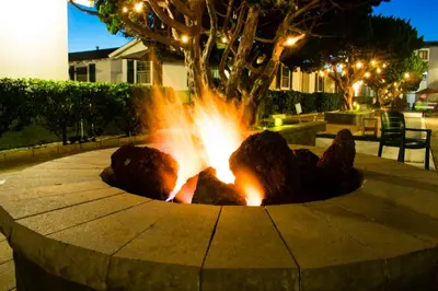 a fire pit in a park at night at The Beach Cottages in San Diego
