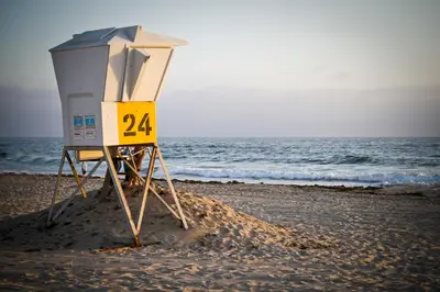 a lifeguard stand on a beach with the ocean at The Beach Cottages in San Diego