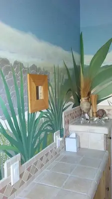 a bathroom with a mural of plants on the wall at Kokopelli's Hideaway in Julian