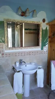 a bathroom with a sink and a mirror at Kokopelli's Hideaway in Julian