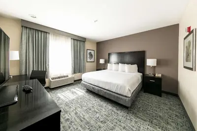 a hotel room with a bed and a desk at Best Western Inn & Suites San Diego Zoo -SeaWorld Area in San Diego