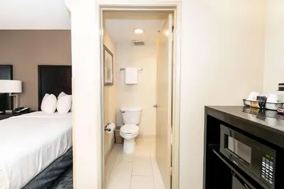a hotel room with a bed and a toilet at Best Western Inn & Suites San Diego Zoo -SeaWorld Area in San Diego