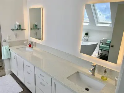 a bathroom with two sinks and two mirrors at 125-Fun In The Sun Penthouse in San Diego