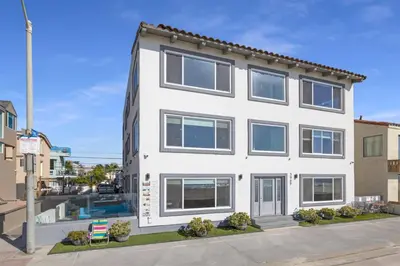 an exterior view of a white building at 120-Oceanfront Penthouse 5 in San Diego
