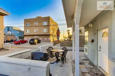 a patio with a table and chairs on a balcony at 201-Surf Stars Studio in San Diego