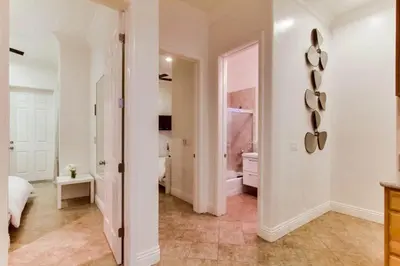 a large white room with a bed and a bathroom at 199-Surf Stars Combo in San Diego