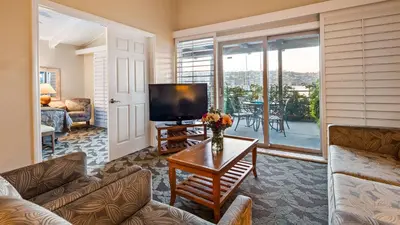 a living room with a tv and a couch and a table at Best Western PLUS Island Palms Hotel & Marina in San Diego