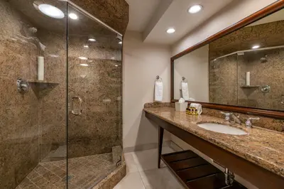 a bathroom with a sink and a glass shower at Best Western PLUS Island Palms Hotel & Marina in San Diego