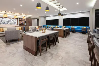 a restaurant with tables and chairs in a room at SpringHill Suites by Marriott Escondido Downtown in Escondido