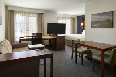a hotel room with a bed and a living room at Residence Inn San Diego Del Mar in San Diego