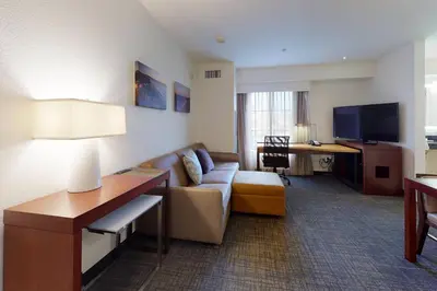 a hotel room with a couch and a desk at Residence Inn San Diego Del Mar in San Diego