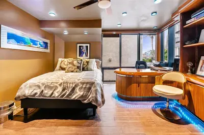 a bedroom with a bed and a desk and a tub at 105-Sleekretreat in San Diego