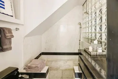 a bathroom with a sink and a shelf with towels at 105-Sleekretreat in San Diego
