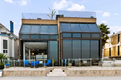 a glass building with blue chairs in front of it at 105-Sleekretreat in San Diego