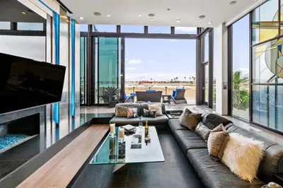 a living room with a couch and a tv at 105-Sleekretreat in San Diego