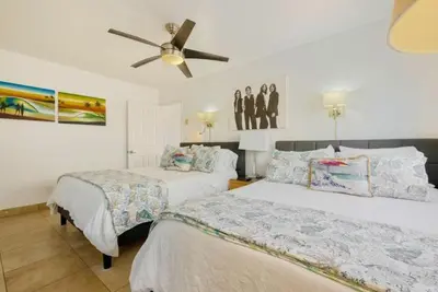 a bedroom with two beds and a ceiling fan at 101-Luxury1 in San Diego