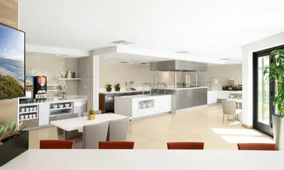 a kitchen and dining room with white counters and tables at Ayres Hotel San Diego South - Chula Vista in Chula Vista