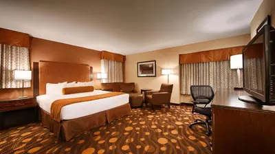 a hotel room with a bed and a television at Best Western Plus Suites Hotel Coronado Island in San Diego