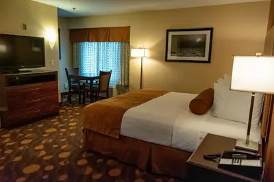 a hotel room with a large bed and a television at Best Western Plus Suites Hotel Coronado Island in San Diego