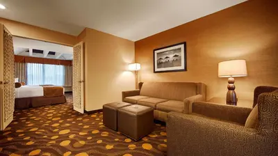 a hotel room with a couch and a bed at Best Western Plus Suites Hotel Coronado Island in San Diego