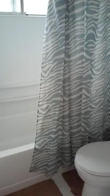 a bathroom with a toilet and a shower curtain at 25 Steps to the Beach in Newport Beach