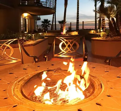 a fire pit in the middle of a patio at Pacific Terrace Hotel in San Diego