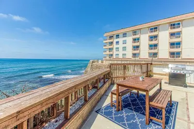 a balcony with a table and a view of the ocean at Ocean Beach Cliffs Sanctuary Oceanfront in San Diego