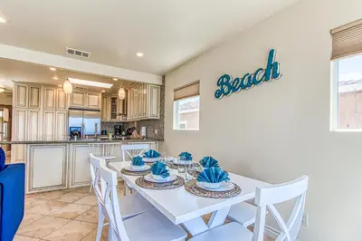 a kitchen and dining room with a white table and chairs at Ocean Beach Cliffs Sanctuary Oceanfront in San Diego