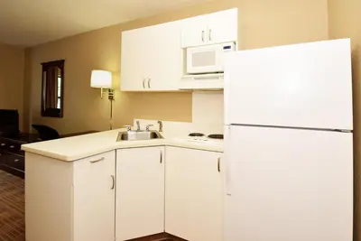a kitchen with white cabinets and a white refrigerator at Extended Stay America Suites - San Diego - Oceanside in Oceanside