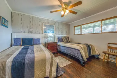 a bedroom with two beds and a ceiling fan at Heart of the Village in Carlsbad
