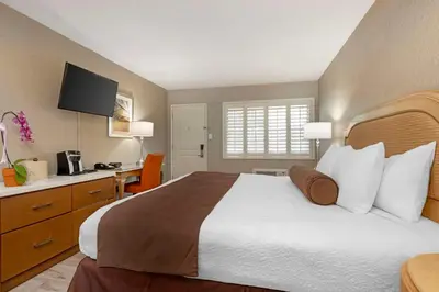a hotel room with a large bed and a desk at Best Western Downtown San Diego in San Diego
