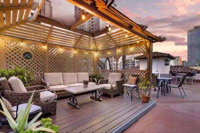 a patio with chairs and tables on a building at Best Western Downtown San Diego in San Diego