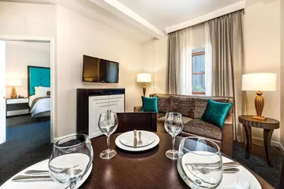 a living room with a table with wine glasses on it at WorldMark San Diego - Balboa Park in San Diego