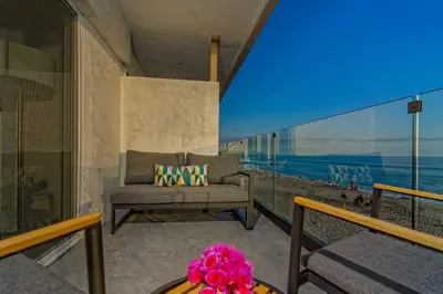 a living room with a couch and a view of the ocean at Ocean Villas Beach Front in Carlsbad