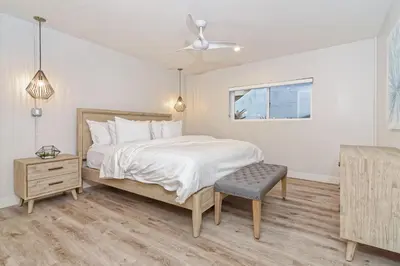 a bedroom with a bed and a ceiling fan at Ocean Villas Beach Front in Carlsbad