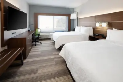 a hotel room with two beds and a flat screen tv at Holiday Inn Express & Suites - Murrieta by IHG in Murrieta