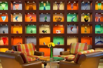 a room with two chairs and a wall of vases at San Diego Marriott Gaslamp Quarter in San Diego