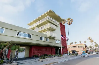 a building on a street with a car parked in front at Surfer Beach Hotel in San Diego