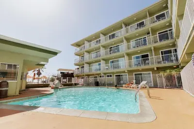 a swimming pool in front of a apartment building at Surfer Beach Hotel in San Diego